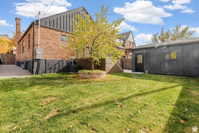 back of property featuring brick siding, board and batten siding, and cooling unit