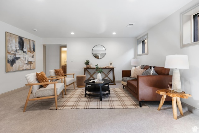 carpeted living area with recessed lighting and baseboards