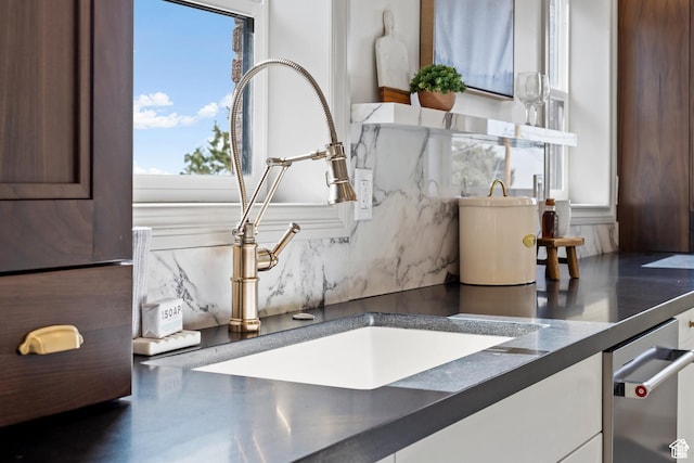 detailed view of a sink and tasteful backsplash