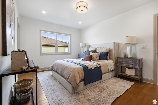 bedroom featuring baseboards, wood finished floors, and recessed lighting