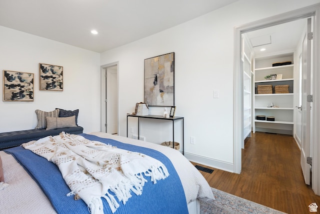 bedroom with wood finished floors, recessed lighting, and baseboards