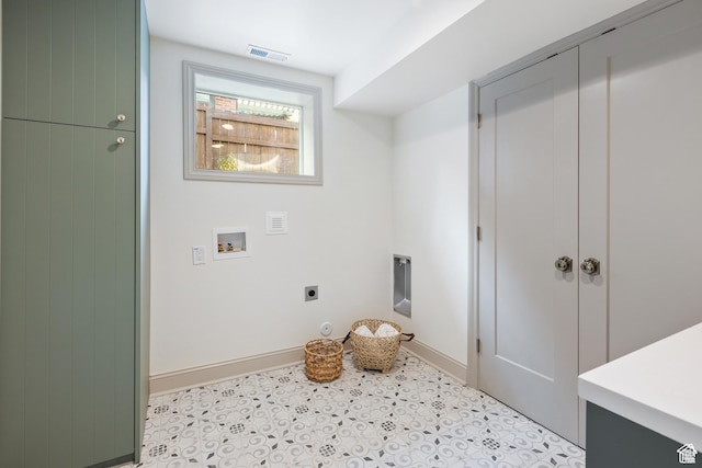 clothes washing area featuring hookup for an electric dryer, washer hookup, baseboards, and light tile patterned floors