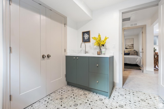 ensuite bathroom featuring vanity and tile patterned floors