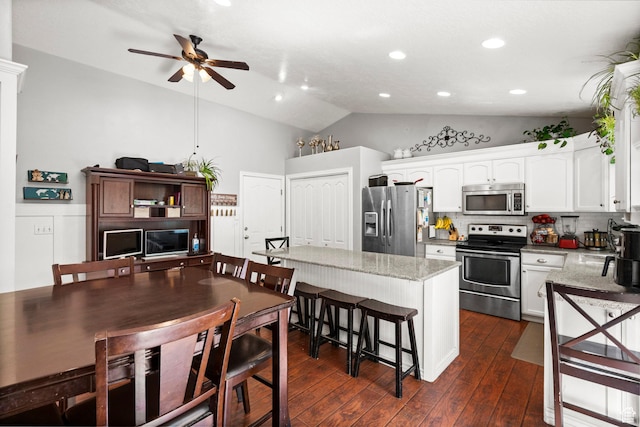 2142 Alaska Ave, Provo, UT 84606 - kitchen with stainless steel appliances, a ceiling fan, lofted ceiling, white cabinetry, and dark wood-style flooring