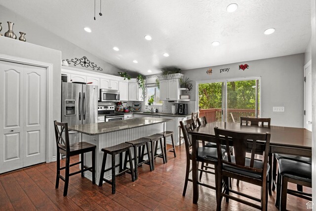 2142 Alaska Ave, Provo, UT 84606 - kitchen featuring appliances with stainless steel finishes, recessed lighting, backsplash, a breakfast bar area, and a kitchen island