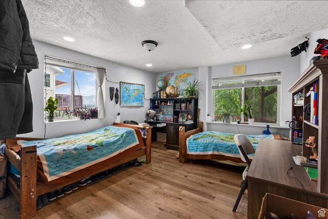 2142 Alaska Ave, Provo, UT 84606 - bedroom featuring a textured ceiling, wood finished floors, multiple windows, and recessed lighting
