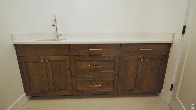 bathroom with a sink and baseboards