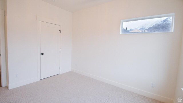 unfurnished bedroom with carpet, baseboards, and a closet