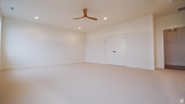 unfurnished bedroom with light colored carpet, recessed lighting, baseboards, a closet, and ceiling fan