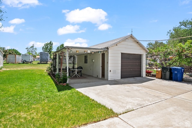 view of front of property featuring concrete driveway, a front lawn, and a garage