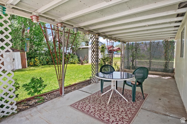 view of patio featuring a shed and an outbuilding