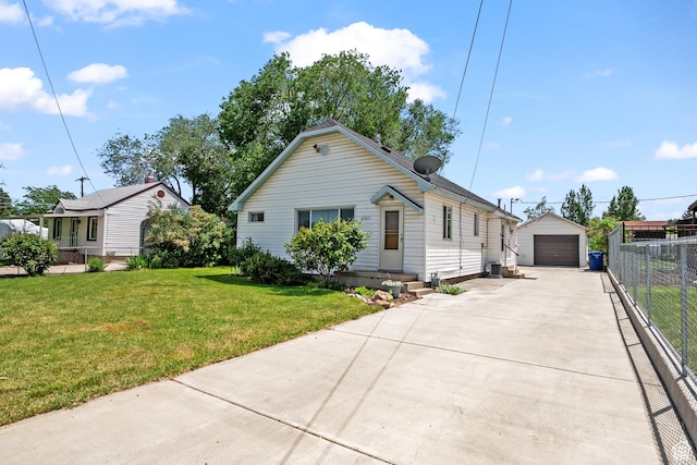 view of front facade with a garage, concrete driveway, and an outbuilding
