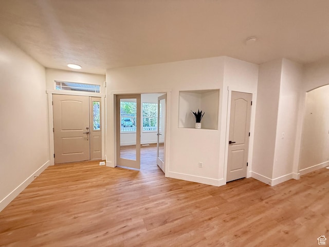 7038 W 8090 S, West Jordan, UT 84081 - foyer entrance featuring baseboards, light wood finished floors, and arched walkways