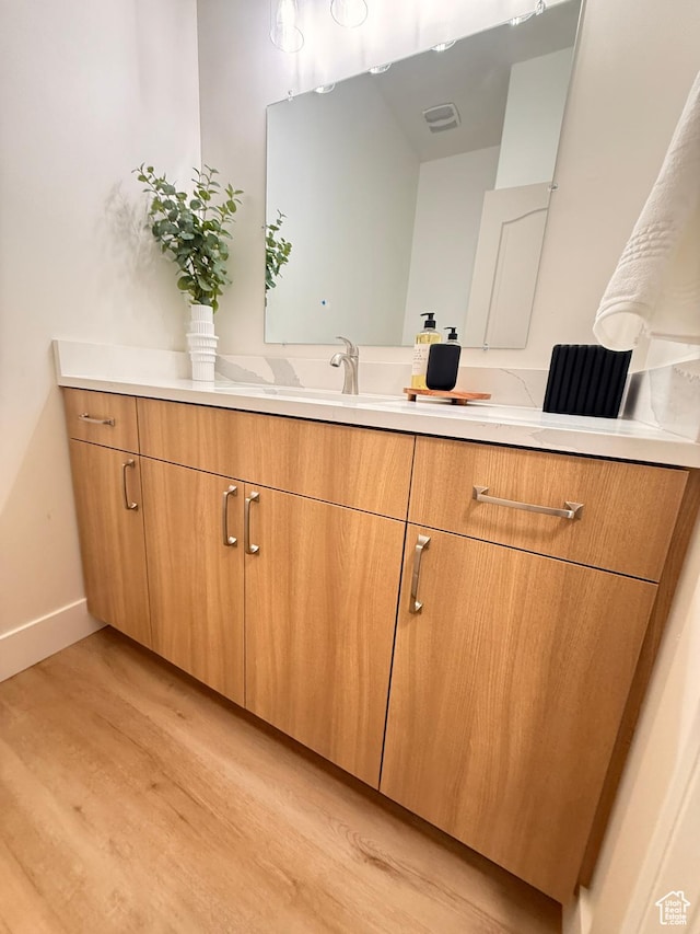 7038 W 8090 S, West Jordan, UT 84081 - bathroom featuring wood finished floors, vanity, and baseboards