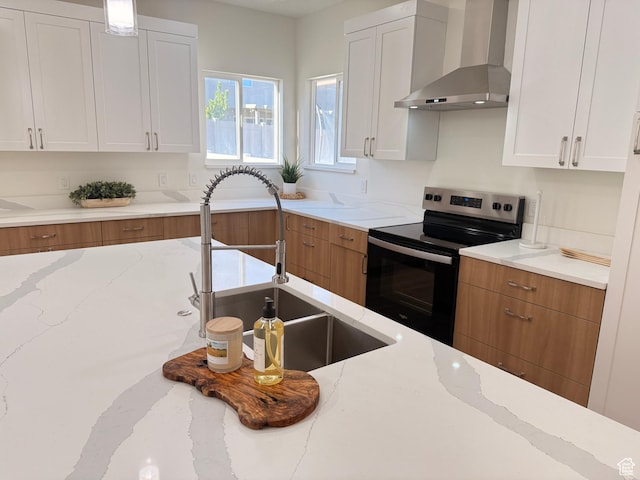 7038 W 8090 S, West Jordan, UT 84081 - kitchen with wall chimney range hood, electric range, a sink, white cabinets, and light stone counters