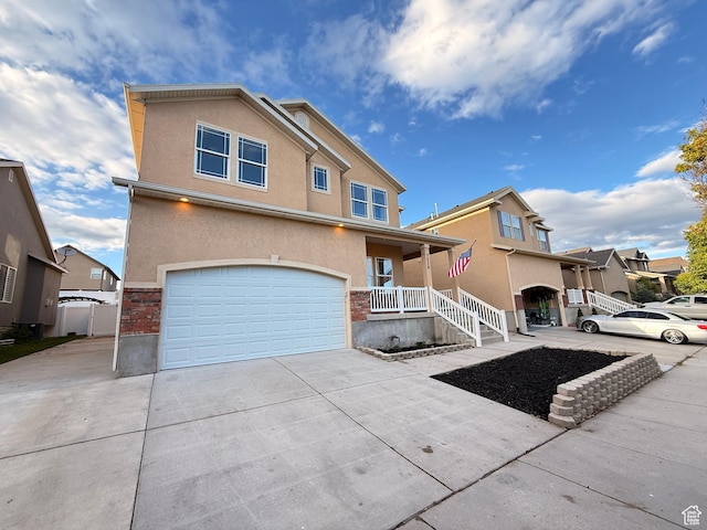 7038 W 8090 S, West Jordan, UT 84081 - traditional-style house featuring an attached garage, concrete driveway, stucco siding, and a porch