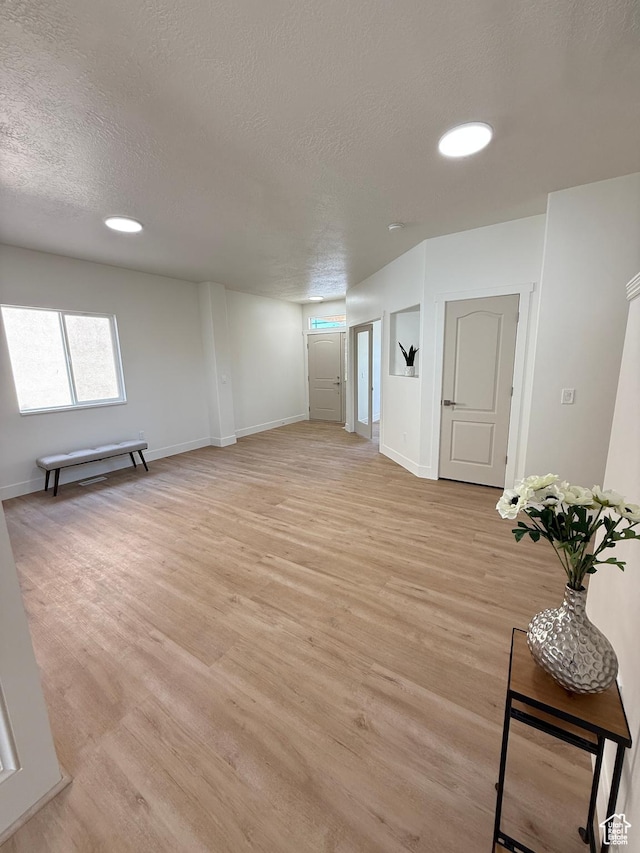 7038 W 8090 S, West Jordan, UT 84081 - spare room featuring a textured ceiling, light wood-style flooring, baseboards, and recessed lighting