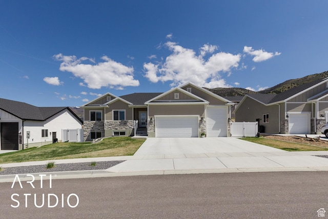 752 N Sunset Dr, Morgan, UT 84050 - craftsman-style home with a garage, stone siding, concrete driveway, a gate, and a mountain view