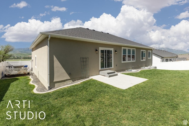 752 N Sunset Dr, Morgan, UT 84050 - back of property featuring stucco siding, a patio area, roof with shingles, and a mountain view