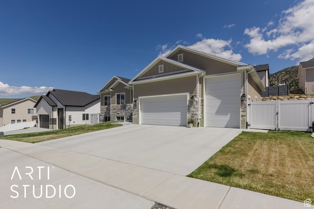 752 N Sunset Dr, Morgan, UT 84050 - view of front facade featuring stone siding, a gate, an attached garage, and driveway
