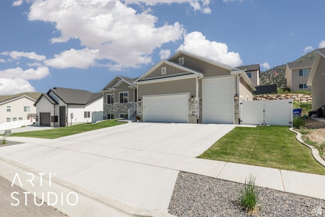 752 N Sunset Dr, Morgan, UT 84050 - view of front of house with a gate, a garage, stone siding, driveway, and a residential view