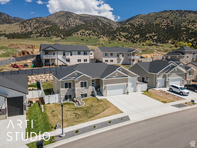 752 N Sunset Dr, Morgan, UT 84050 - view of front of property featuring stone siding, a residential view, concrete driveway, and an attached garage