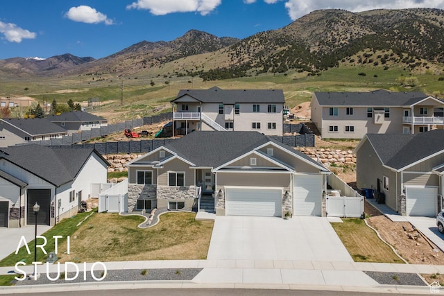 752 N Sunset Dr, Morgan, UT 84050 - view of front facade featuring a gate, a garage, stone siding, driveway, and a mountain view