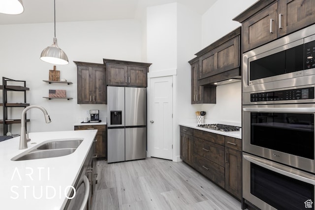 752 N Sunset Dr, Morgan, UT 84050 - kitchen featuring stainless steel appliances, a sink, dark brown cabinets, and light countertops