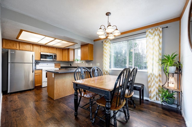 2135 W 4300 S, Roy, UT 84067 - dining space with dark wood-type flooring, a chandelier, and baseboards