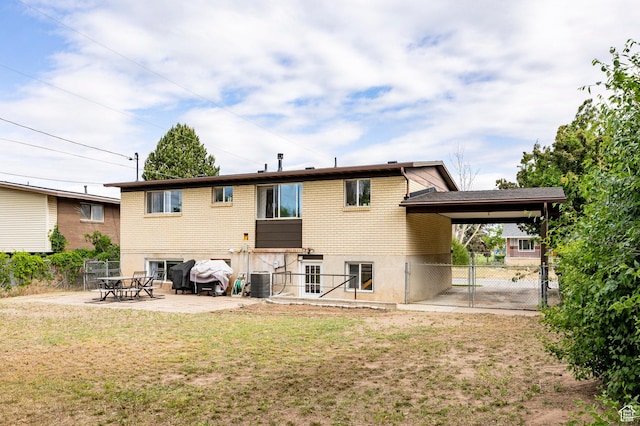 2135 W 4300 S, Roy, UT 84067 - rear view of house featuring a gate, central AC, an attached carport, a patio area, and brick siding
