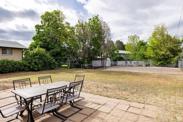 2135 W 4300 S, Roy, UT 84067 - view of patio / terrace featuring outdoor dining area, a storage shed, and an outbuilding