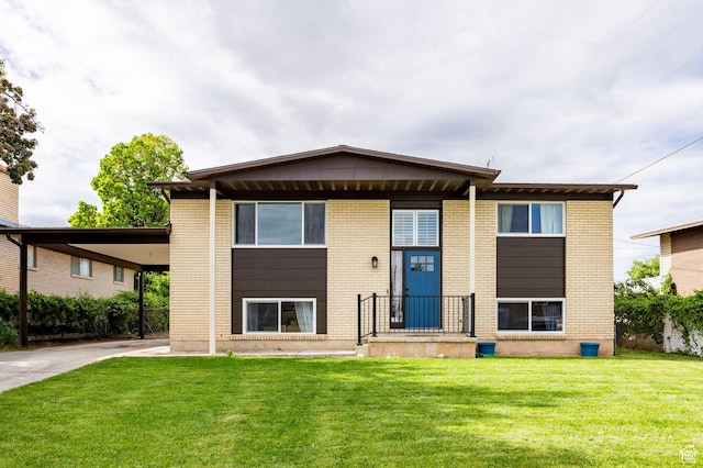 2135 W 4300 S, Roy, UT 84067 - split level home featuring a front lawn, brick siding, driveway, and a carport