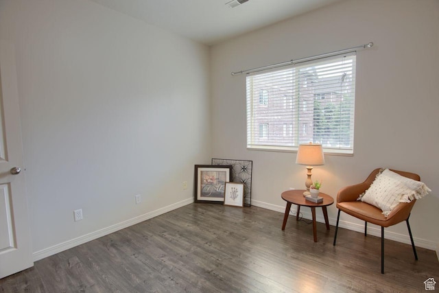 sitting room with wood finished floors and baseboards