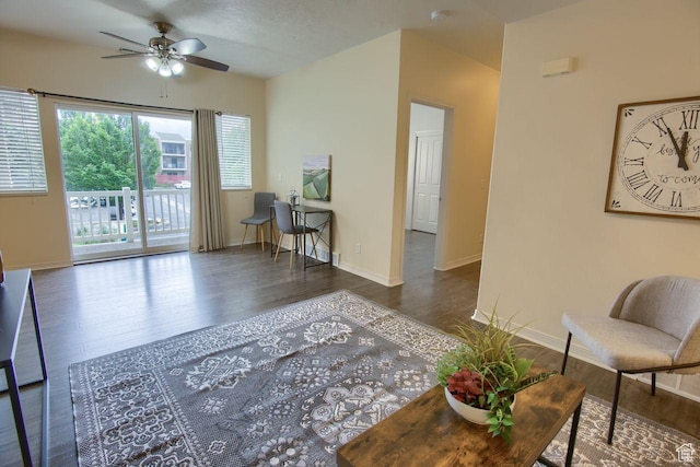 living area featuring a ceiling fan, wood finished floors, and baseboards