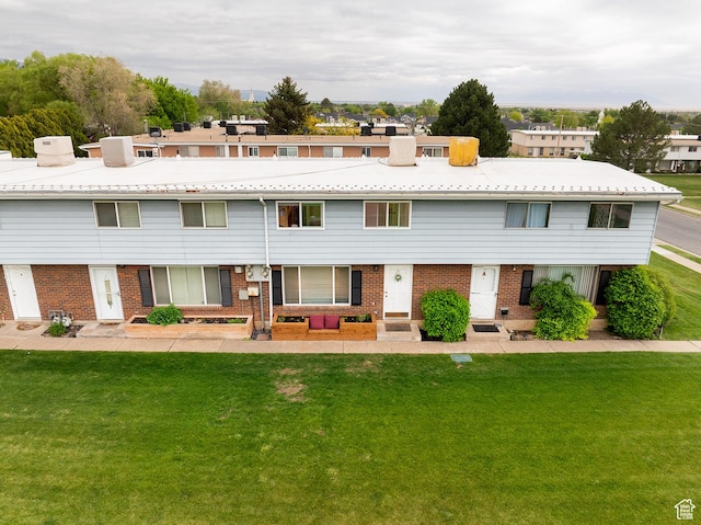 1088 N Nayon Dr Unit B, Layton, UT 84040 - view of property featuring brick siding, a front yard, a chimney, and entry steps