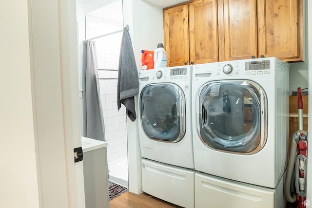 1088 N Nayon Dr Unit B, Layton, UT 84040 - washroom featuring separate washer and dryer, cabinet space, and light wood-style floors