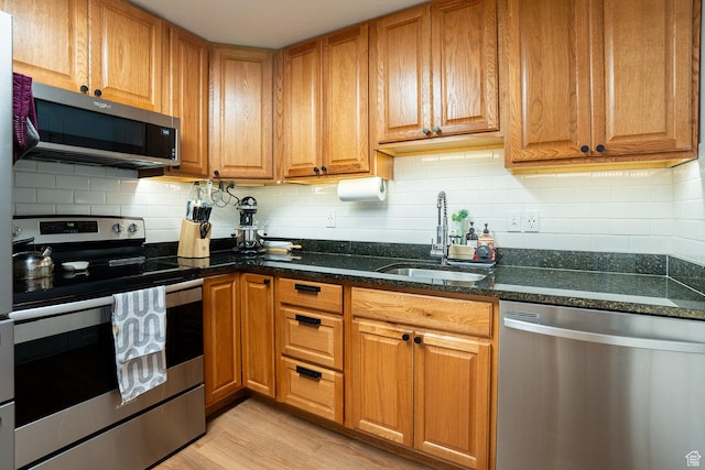 1088 N Nayon Dr Unit B, Layton, UT 84040 - kitchen with appliances with stainless steel finishes, a sink, tasteful backsplash, and dark stone countertops