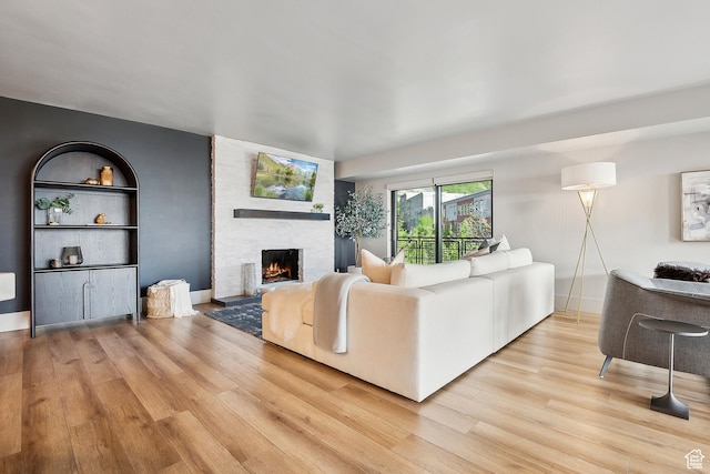 900 S Donner Way E Unit 707, Salt Lake City, UT 84108 - living room with light wood-style floors and a fireplace
