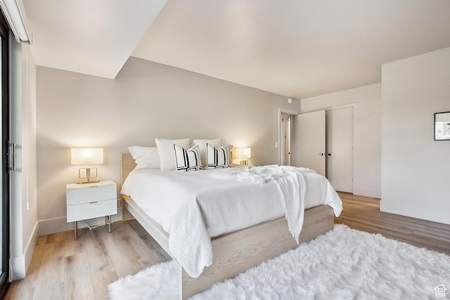 900 S Donner Way E Unit 707, Salt Lake City, UT 84108 - bedroom featuring wood finished floors and a closet