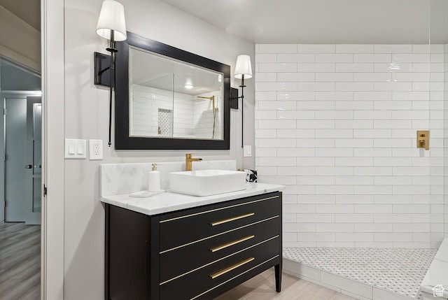 900 S Donner Way E Unit 707, Salt Lake City, UT 84108 - bathroom with vanity, a tile shower, and wood finished floors