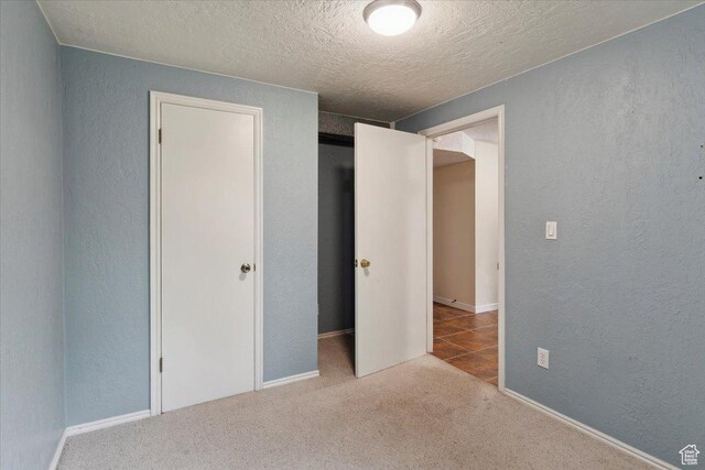 22 W 1470 S, Farmington, UT 84025 - unfurnished bedroom featuring a textured wall, a textured ceiling, and carpet flooring