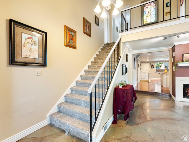 450 W Chokecherry Cir, Orem, UT 84058 - stairway featuring ornamental molding, a lit fireplace, baseboards, and a chandelier