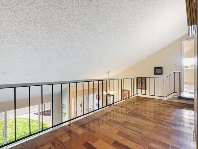 450 W Chokecherry Cir, Orem, UT 84058 - hallway with a textured ceiling, hardwood / wood-style flooring, and vaulted ceiling
