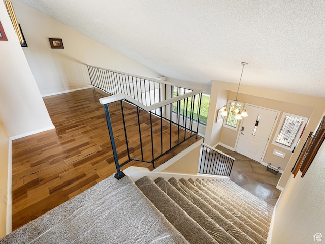 450 W Chokecherry Cir, Orem, UT 84058 - staircase with a chandelier, a textured ceiling, baseboards, and wood finished floors
