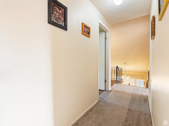450 W Chokecherry Cir, Orem, UT 84058 - hallway featuring carpet, a textured ceiling, a chandelier, and baseboards