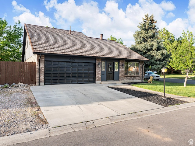 450 W Chokecherry Cir, Orem, UT 84058 - view of front of property featuring brick siding, a garage, and concrete driveway