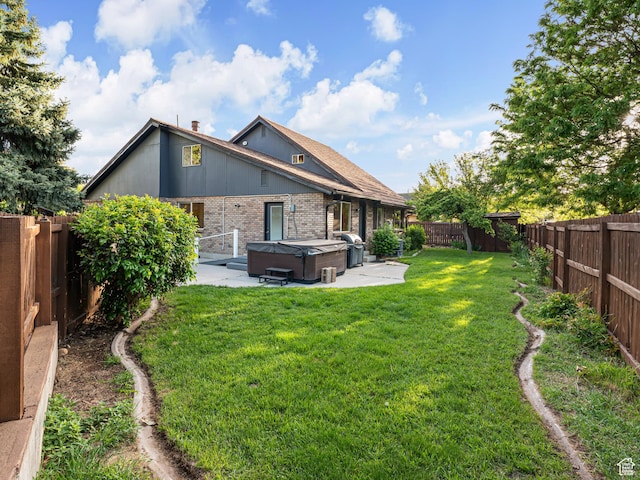 450 W Chokecherry Cir, Orem, UT 84058 - back of house with a hot tub, a patio area, and brick siding