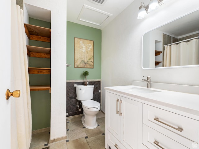 450 W Chokecherry Cir, Orem, UT 84058 - bathroom featuring toilet, vanity, tile walls, and a wainscoted wall