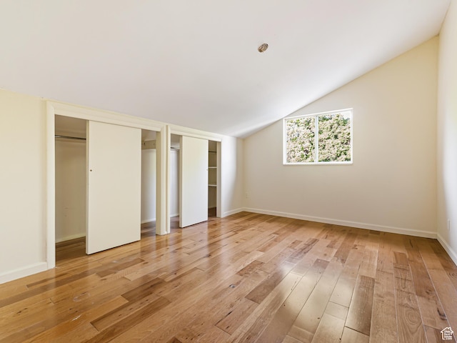 450 W Chokecherry Cir, Orem, UT 84058 - unfurnished bedroom with multiple closets, light wood finished floors, vaulted ceiling, and baseboards