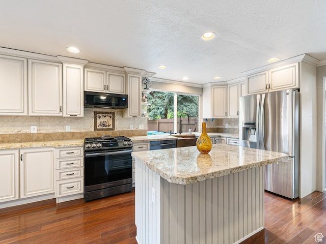 450 W Chokecherry Cir, Orem, UT 84058 - kitchen with appliances with stainless steel finishes, a sink, dark wood-type flooring, tasteful backsplash, and crown molding